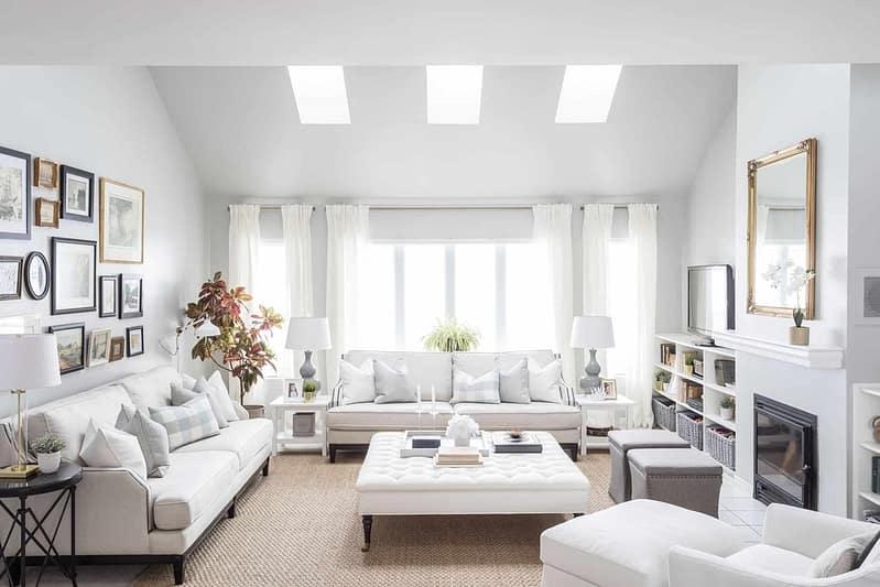 Bright white living room with a bright window above a couch